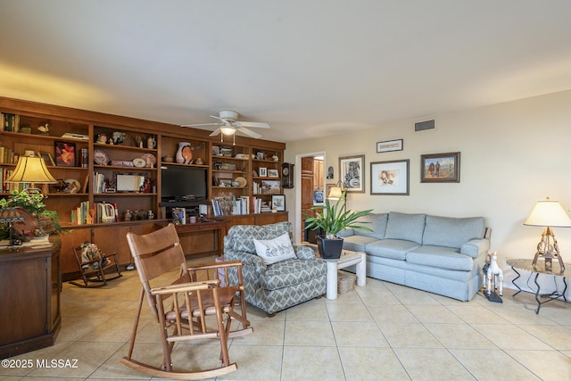 living area with a ceiling fan, visible vents, and light tile patterned flooring