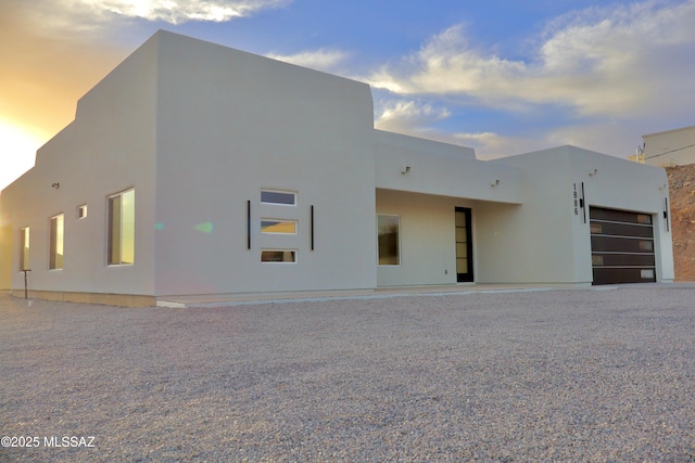 view of front of property featuring a garage and stucco siding