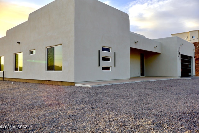 rear view of house with stucco siding