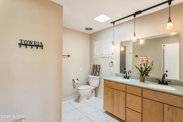 full bath with double vanity, a sink, toilet, and tile patterned floors