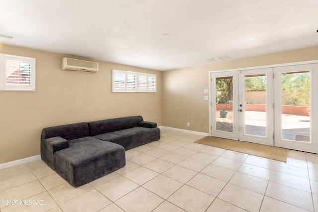 living room featuring light tile patterned floors, visible vents, baseboards, french doors, and a wall mounted air conditioner