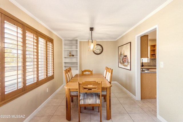 dining room with light tile patterned floors, ornamental molding, and baseboards