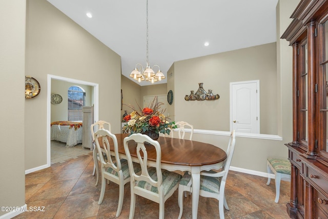 dining space featuring baseboards, an inviting chandelier, lofted ceiling, recessed lighting, and stone finish flooring