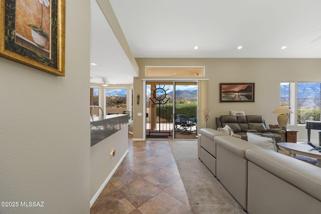 living area with a wealth of natural light, recessed lighting, baseboards, and ceiling fan