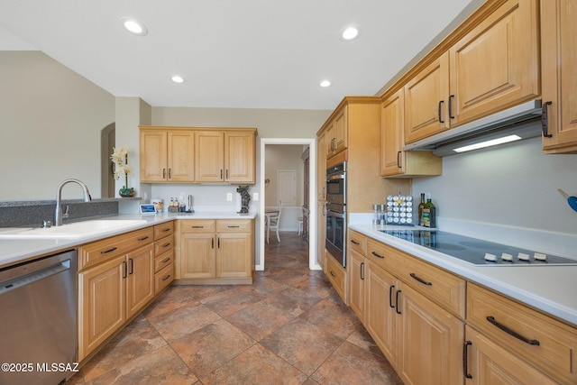 kitchen featuring under cabinet range hood, appliances with stainless steel finishes, light brown cabinetry, and a sink