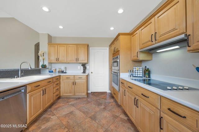 kitchen featuring light brown cabinets, a sink, stainless steel appliances, light countertops, and under cabinet range hood