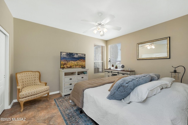 bedroom featuring a ceiling fan and baseboards