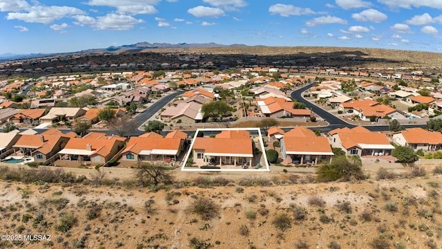 drone / aerial view featuring a residential view and a mountain view