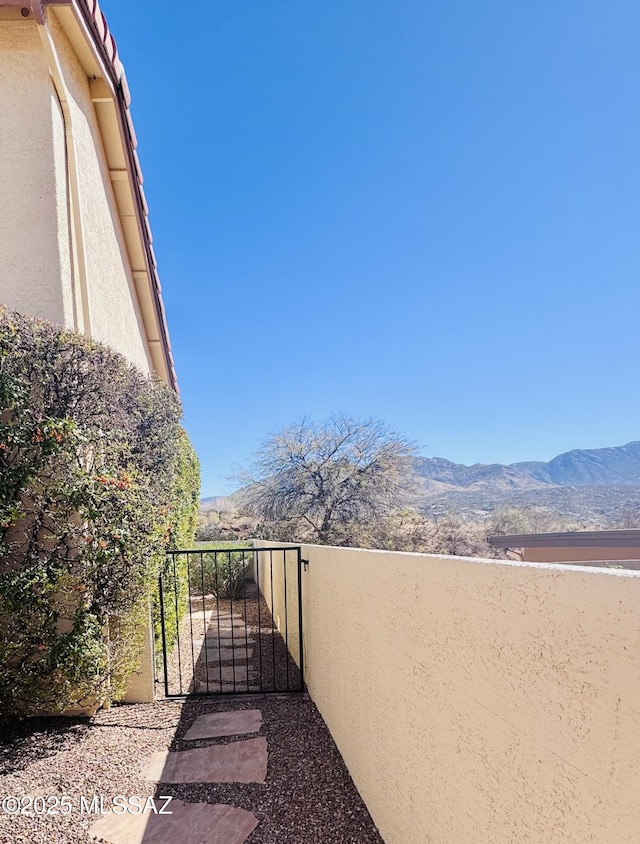 exterior space with a gate and a mountain view