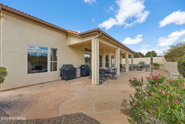 view of patio featuring area for grilling and fence