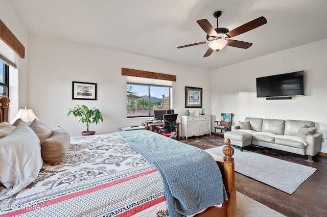 bedroom with ceiling fan and concrete floors