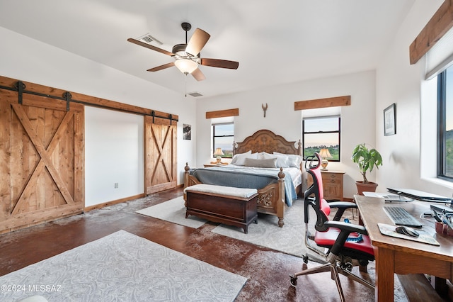 bedroom featuring concrete flooring, a barn door, visible vents, and baseboards