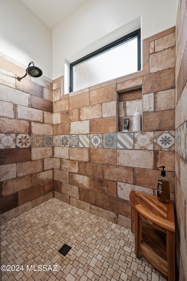 bathroom with tiled shower