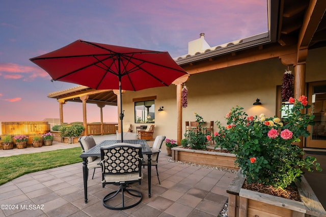 patio terrace at dusk with outdoor dining area