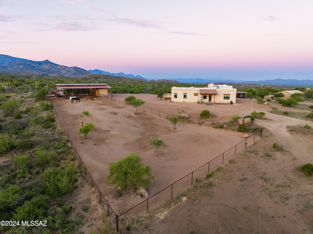 aerial view at dusk with a rural view and a mountain view