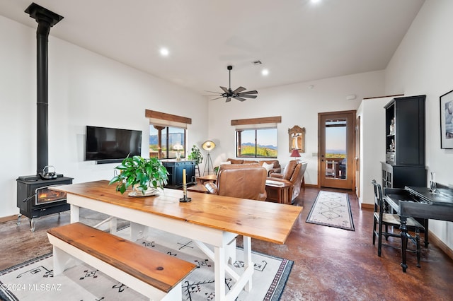 office featuring a wood stove, finished concrete flooring, a ceiling fan, and recessed lighting