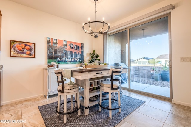 dining area with an inviting chandelier, light tile patterned floors, and baseboards