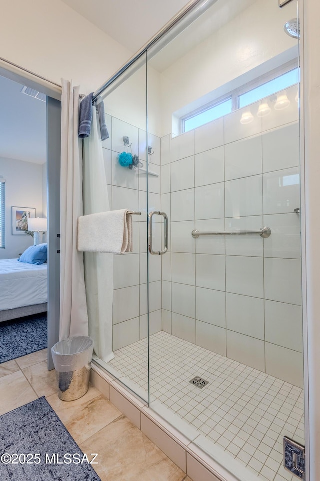 ensuite bathroom featuring ensuite bath and a shower stall