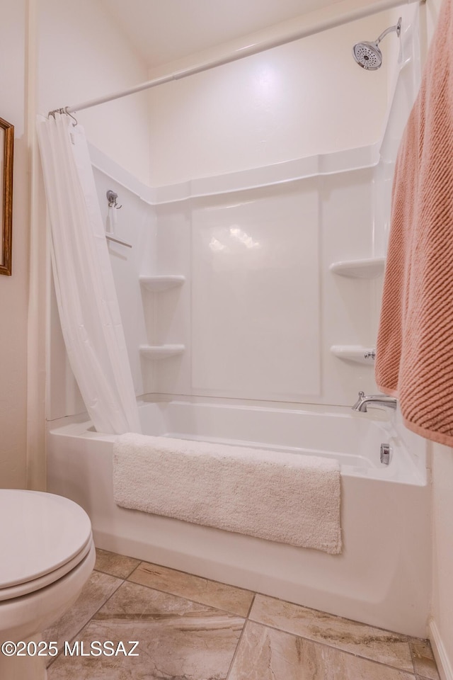 bathroom featuring toilet and shower / bath combo with shower curtain