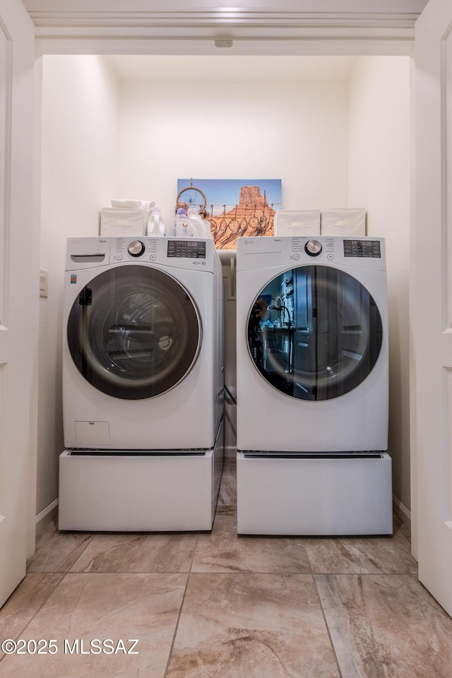 laundry room with washer and dryer and laundry area