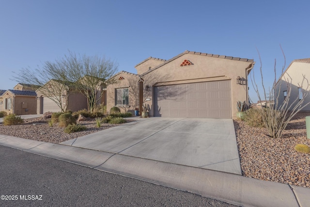 mediterranean / spanish-style home with an attached garage, a tiled roof, concrete driveway, and stucco siding