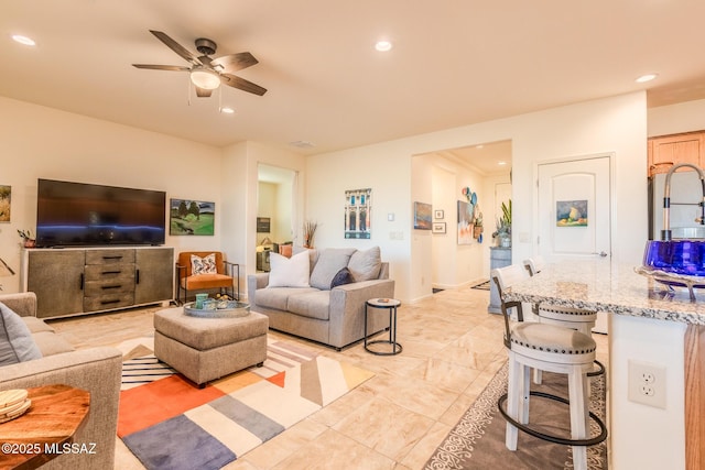 living room featuring a ceiling fan and recessed lighting