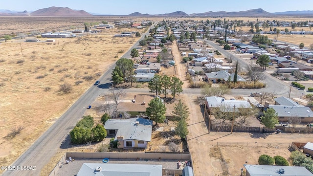 drone / aerial view featuring a mountain view and a desert view