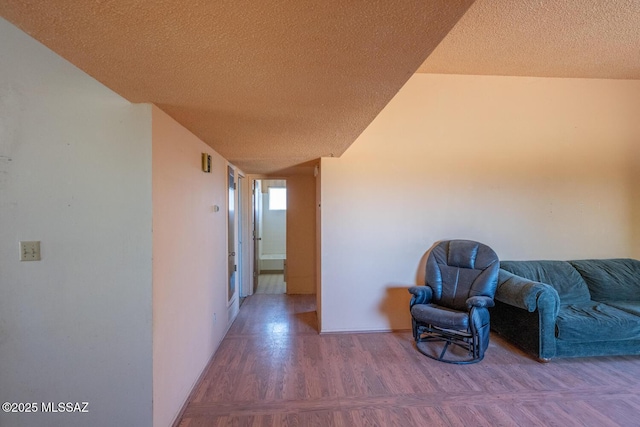 corridor featuring a textured ceiling and parquet floors