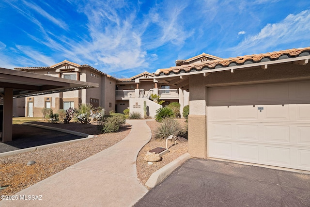 view of front of house with stucco siding and a tiled roof