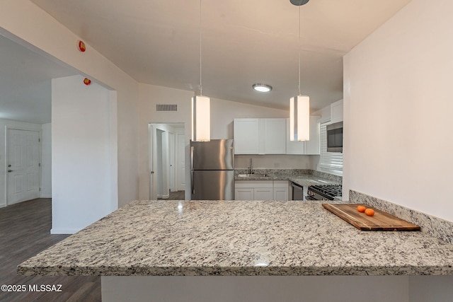 kitchen featuring light stone counters, dark wood-style flooring, a sink, white cabinetry, and appliances with stainless steel finishes