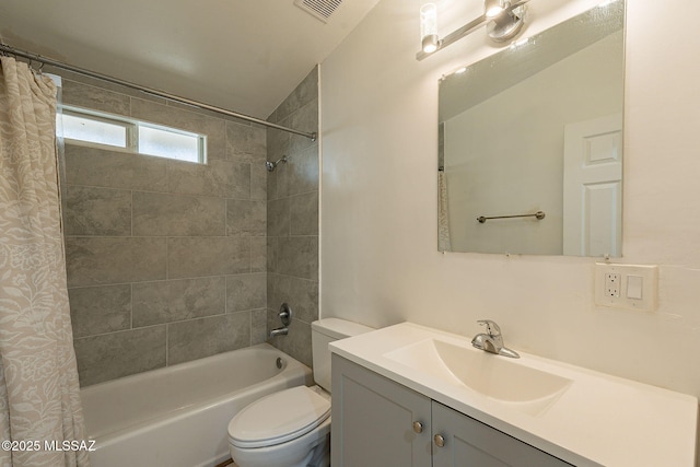 full bathroom featuring toilet, shower / bath combo, vanity, and visible vents