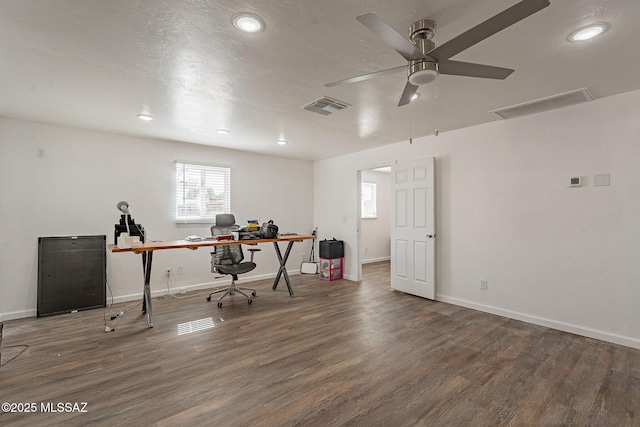 office with a textured ceiling, wood finished floors, visible vents, and baseboards