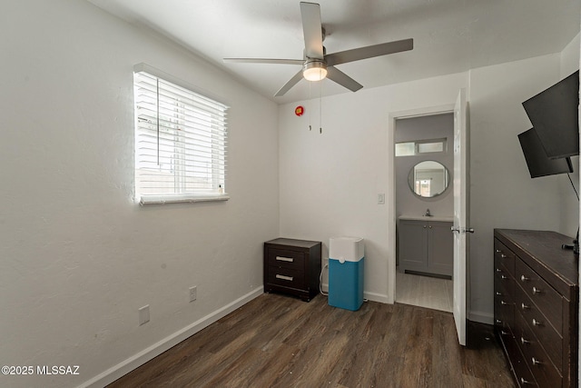 unfurnished bedroom featuring a ceiling fan, dark wood-style flooring, and baseboards