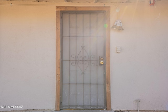 doorway to property with stucco siding