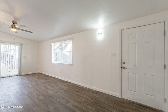 unfurnished room featuring a ceiling fan, baseboards, vaulted ceiling, and dark wood-style flooring