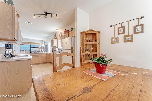 dining space featuring light tile patterned floors and visible vents