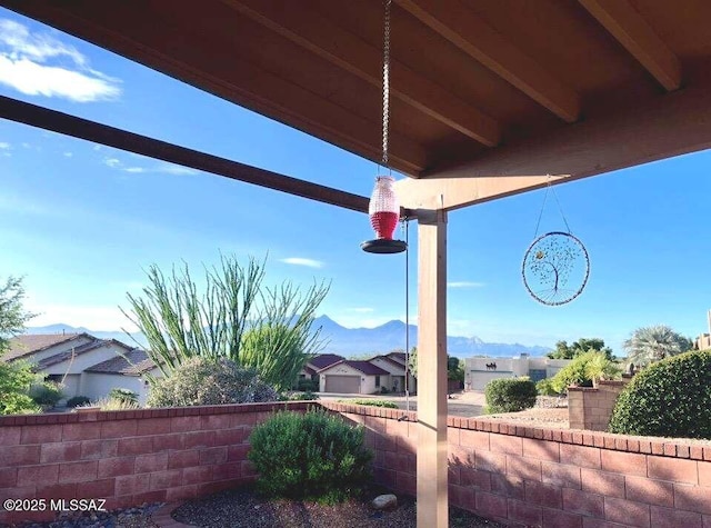 exterior space featuring a mountain view and fence