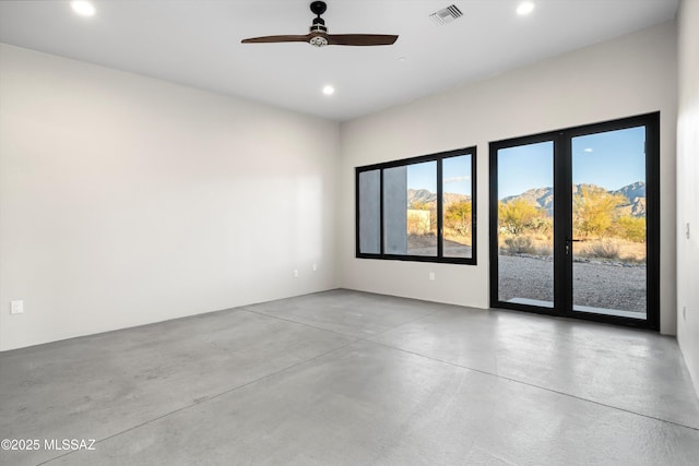 unfurnished room featuring visible vents, recessed lighting, and finished concrete flooring