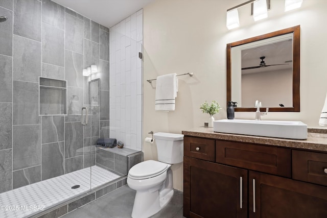 bathroom with vanity, toilet, and a shower stall