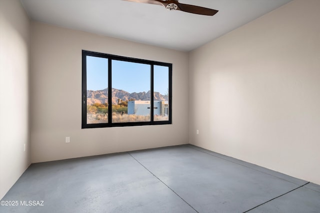 empty room featuring concrete flooring and ceiling fan