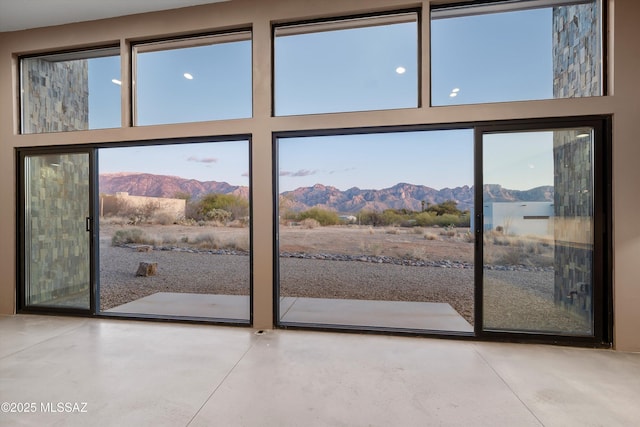 doorway with a mountain view and concrete floors