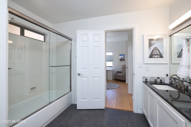 bathroom with enclosed tub / shower combo and vanity