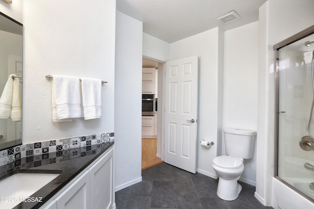 bathroom with visible vents, toilet, enclosed tub / shower combo, vanity, and baseboards