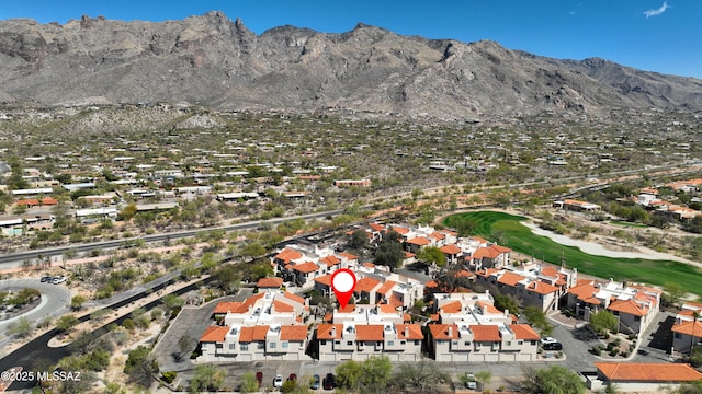 aerial view featuring view of golf course, a residential view, and a mountain view