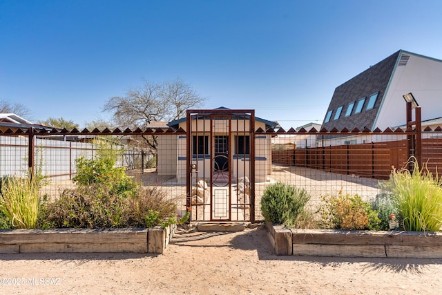 view of outbuilding featuring fence private yard and a gate