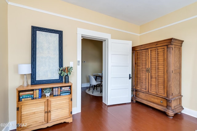 interior space featuring dark wood-style floors and baseboards