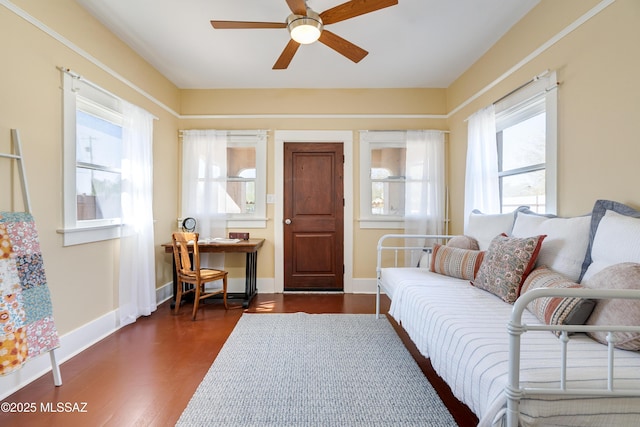 sitting room with dark wood-type flooring, ceiling fan, and baseboards