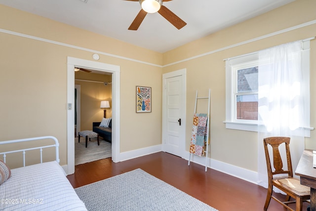 bedroom with a ceiling fan, dark wood-style flooring, and baseboards