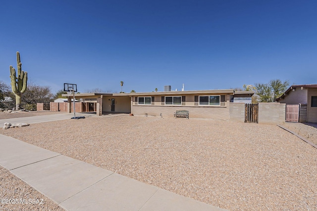 view of front of house with a gate, fence, and brick siding