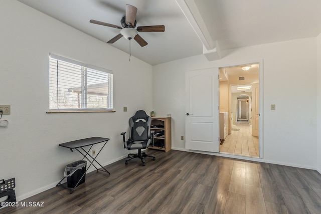 home office with dark wood-type flooring, beamed ceiling, baseboards, and a ceiling fan